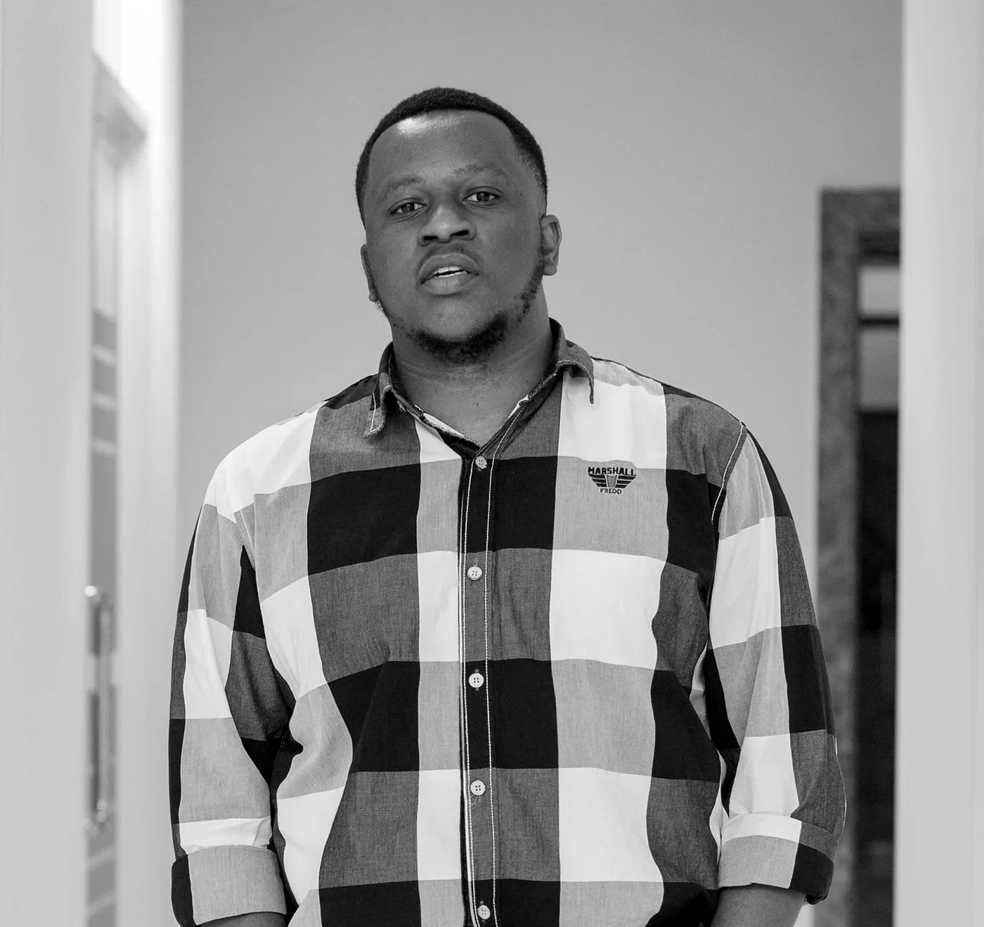 Ignas Bangi standing in a bright hallway